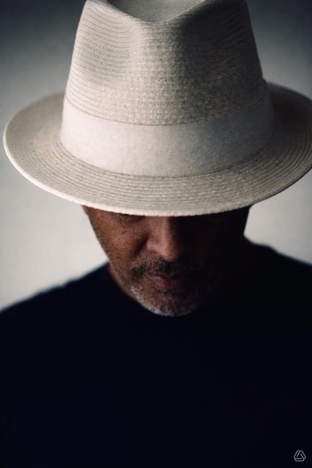 Stephen Wilkerson portrait wearing a cream straw fedora